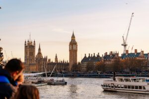 Thames River Sightseeing boat Mercia cruising past Big Ben and the Houses of Parliament in London.