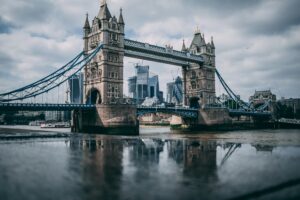 Tower Bridge London landmark with River Thames and city skyline under overcast sky